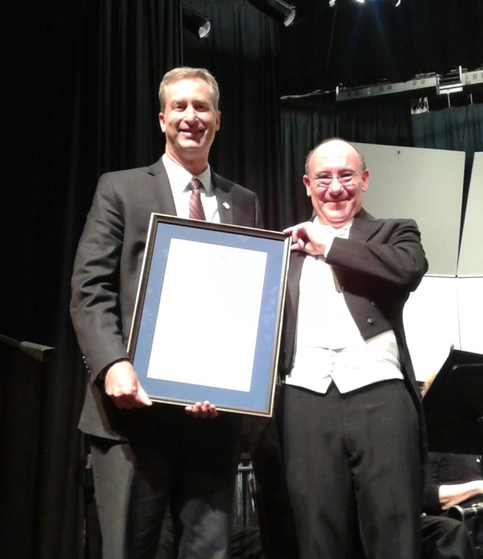 Delegate David Bulova with Music Director Bob Pouliot receiving a proclamation in honor of the CFB's upcoming trip to France