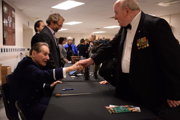 Col. Arnald Gabriel meeting guests and signing his book "Force of Desitny"